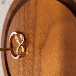 Infinity gold-tone Ring Size: 6 Material: Base Alloy/Base Metal Brand Unknown